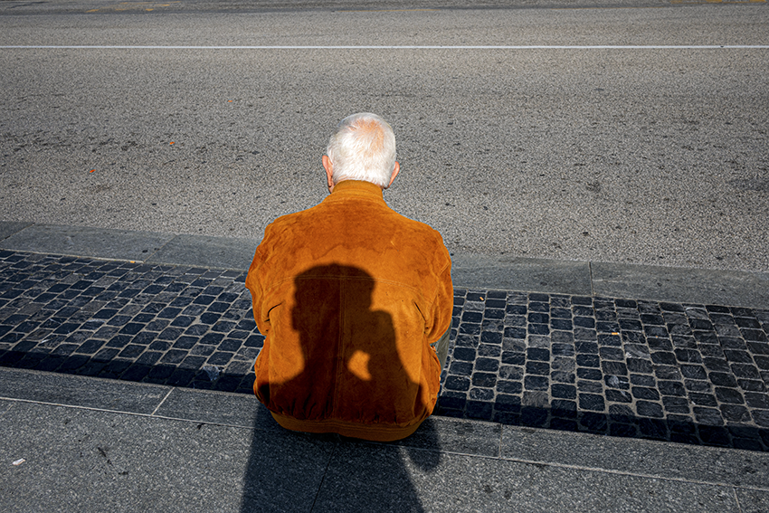 shadow of the photographer in the back of a man